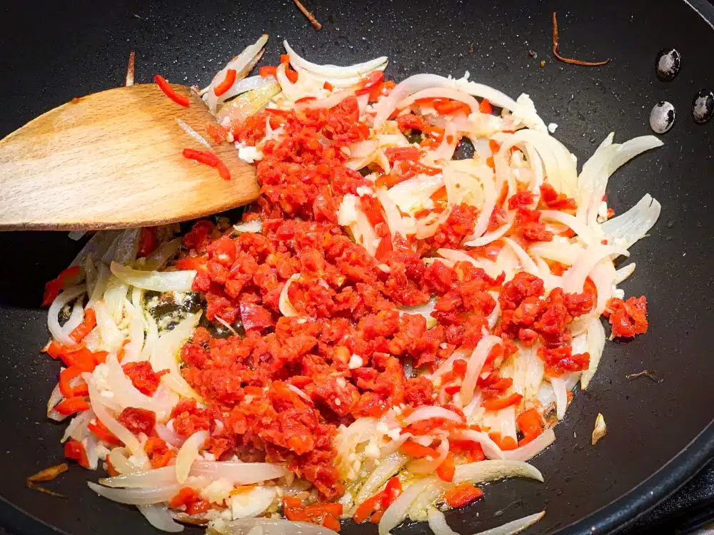 Ui knoflook en chorizo voor de cataplana